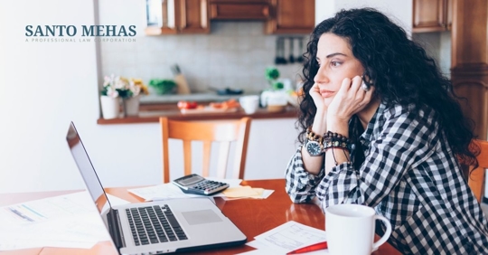 Woman sitting at a table on the computer.