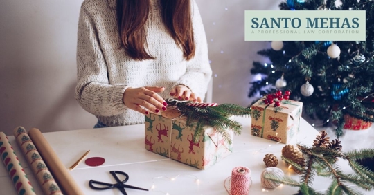 Woman wrapping presents on table.
