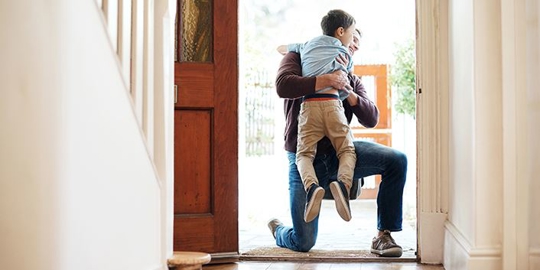 Father hugging his son.