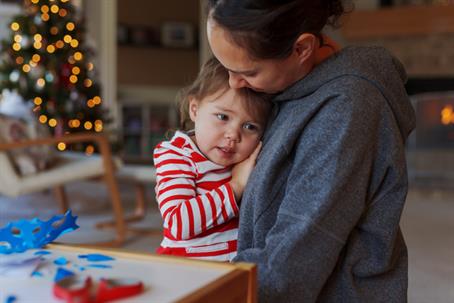 mother hugging daughter during Christmas