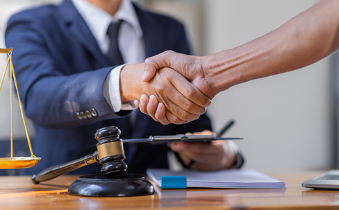 client shaking hands with lawyer