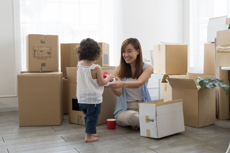 mother and daughter surrounded by moving boxes