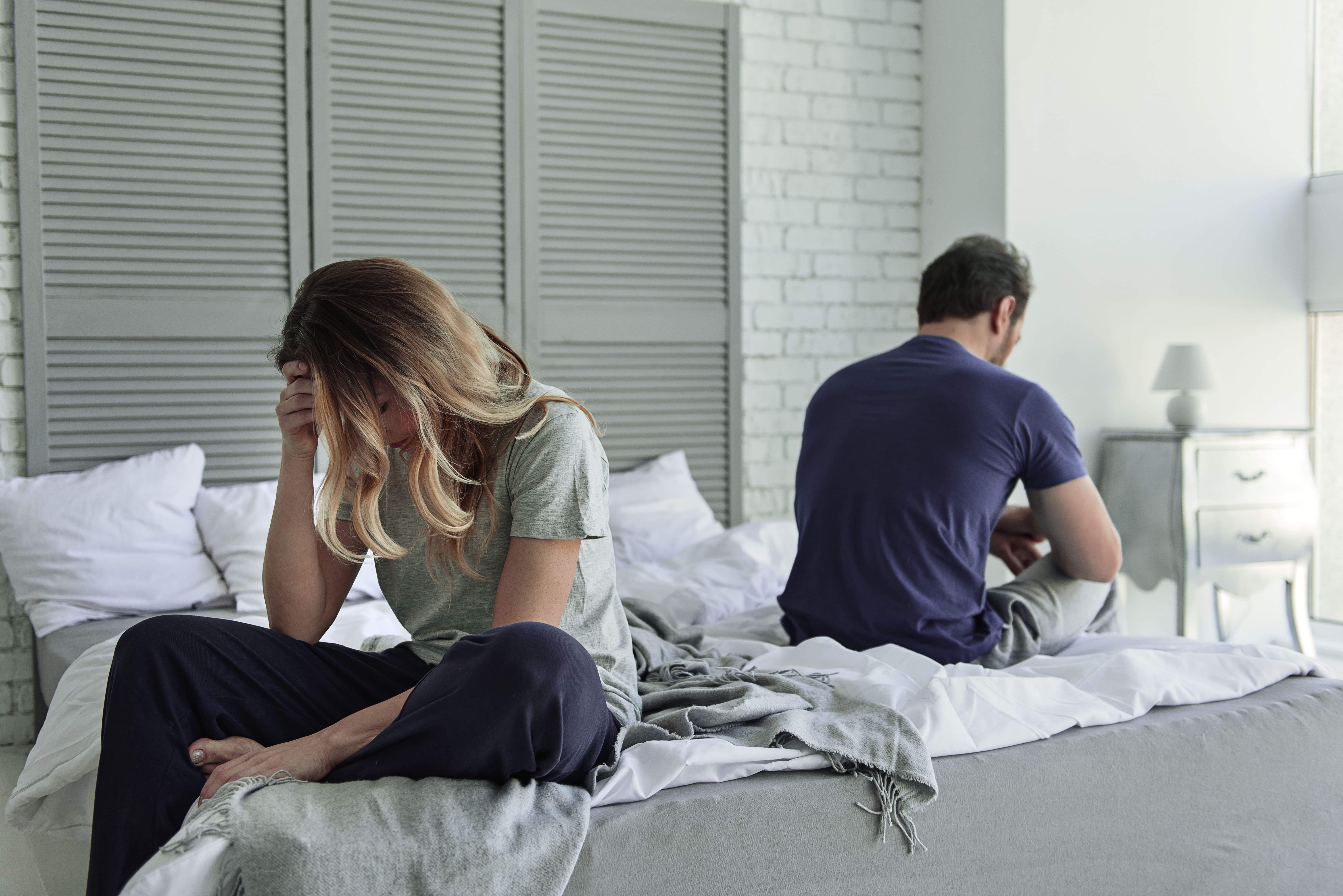 Ventura couple in disagreement sitting on opposite sides of a bed